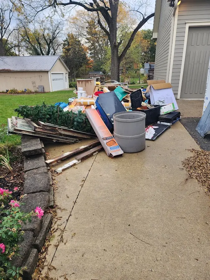 Dumpster being loaded with debris for Estate Cleanout Dumpster Rental in Harvard